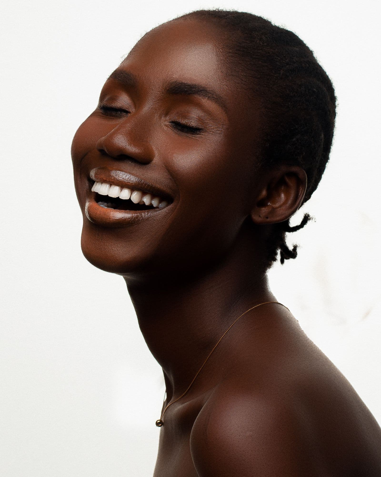 A radiant woman smiling with healthy, glowing skin