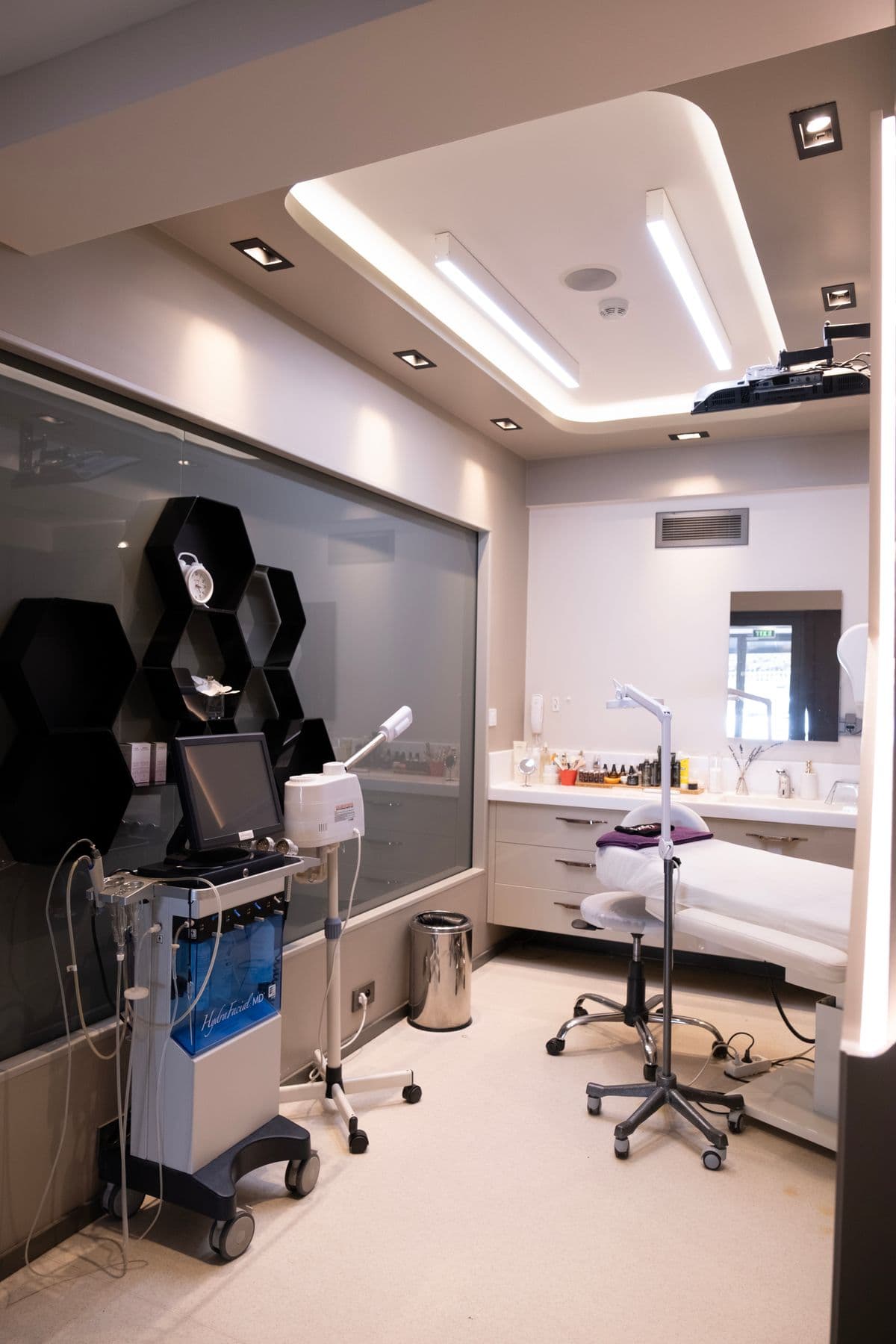 A serene Rosewood treatment room with a facial bed and equipment